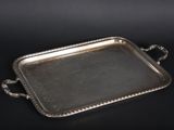 a silver tray with handles and handles on a black surface