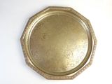 a gold plate on a white table with a white background
