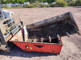 a red dump truck that is sitting in the dirt