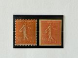 two stamps with a woman and a man on them on a white wall