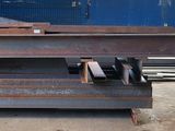 a large pile of steel sitting in a warehouse