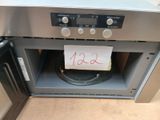 une pancarte sur la porte d'un four, sur laquelle est collée une note