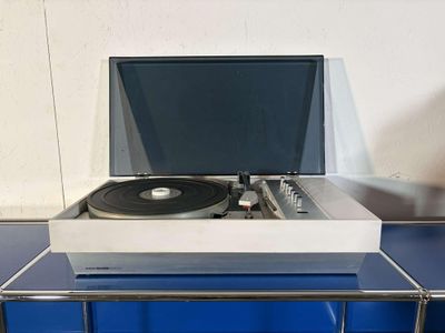 a record player sitting on top of a glass table