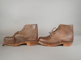 pair of men ' s brown leather boots with laces on them