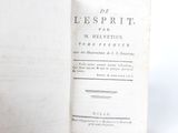 an old book that is open on a white surface