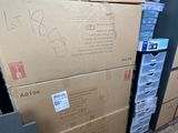 many boxes stacked on top of each other in a room