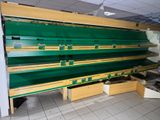 many empty shelves in a store that are green and yellow
