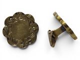a close up of a pair of brass cuff rings on a white surface