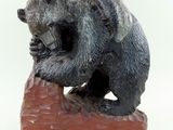 une statue représentant un ours assis sur un rocher