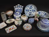 a lot of blue and white dishes and cups on a table