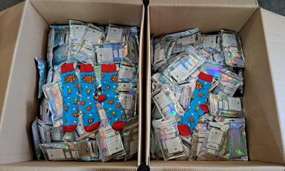 two boxes filled with lots of money sitting on top of a table
