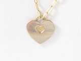 necklace with a heart pendant on a gold chain on a white background
