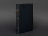 a black book sitting on top of a gray surface