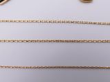 three different types of gold necklaces on a white surface