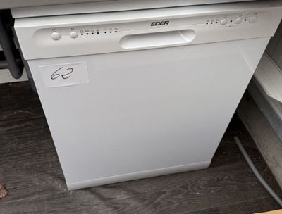 a white dishwasher sitting on the floor next to a window