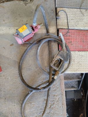 a hose that is sitting on the ground next to a piece of metal