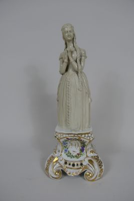 a statue of a woman standing on top of a table