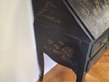 a black writing desk with gold writing on it