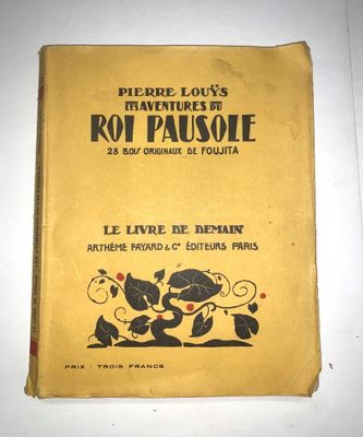 un vieux livre sur lequel figure l'image d'un chien et d'un chat