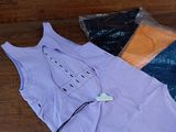 a purple shirt with a tag on it sitting on a table