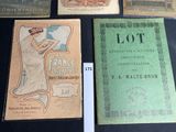 several old books are sitting on a table with a lot of them