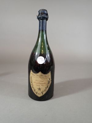an old bottle of wine sitting on a table with a label on it