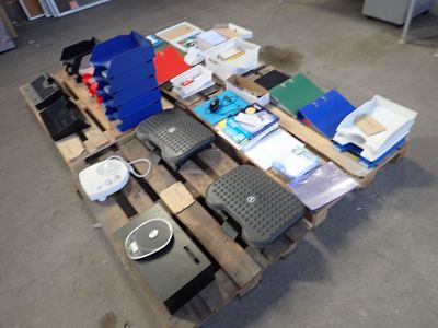 a pile of electronics on a pallet in a warehouse