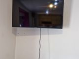 a flat screen tv mounted on the wall in the corner of a room