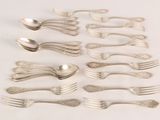 a lot of silver spoons and forks on the table