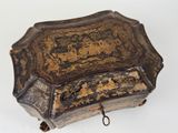 an old box that has been decorated with gold and black designs
