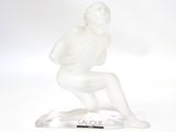statue of a man kneeling on a base with a pen in his hand