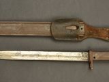 two old knives are sitting on a table next to each other