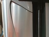 a close up of a stainless steel refrigerator on a counter