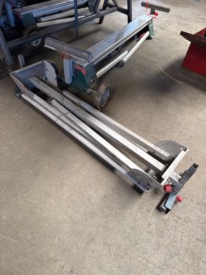 a dolly that is sitting on the ground next to a table