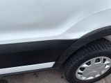 a close up of a white truck parked in a parking lot