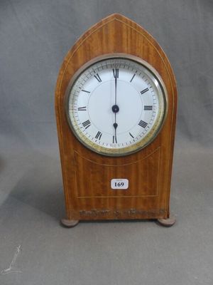 a small wooden clock with roman numerals on it