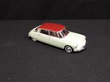 an image of a toy car with a red roof on a black surface