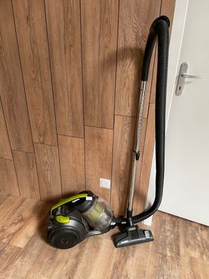 un aspirateur posé sur le sol à côté d'une porte