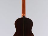 an acoustic guitar hanging from a string on a white background
