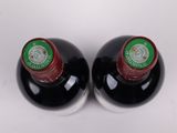 two bottles of wine that are sitting on a table