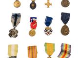 an assortment of medals and medals are displayed on a white surface