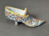 a close up of a miniature shoe on a gray surface