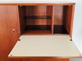 a close up of a wooden cabinet with shelves and shelves