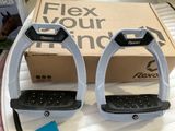 pair of black and white stir stirs on a table with a box of flex your horse