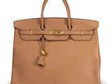 a tan leather handbag with gold hardware on the handle