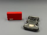 a small metal object with a red box next to it