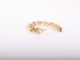 a close up of a gold ring on a white surface