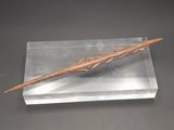 an image of a wooden stick on a clear display case