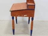 a small wooden desk with a drawer on top of it