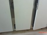 two refrigerators that are next to each other in a room
